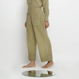 Left View of a Model wearing Khaki Green Vegetable Dyed Handspun Cotton Patch Pocket Wide Legged Pant