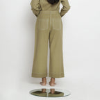 Back View of a Model wearing Khaki Green Vegetable Dyed Handspun Cotton Patch Pocket Wide Legged Pant