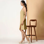Left View of a Model wearing Khaki Sage Cotton Flax Strappy Slit Dress
