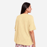 Back View of a Model wearing Lemon Yellow Yarn Dyed Cotton High-Low Top