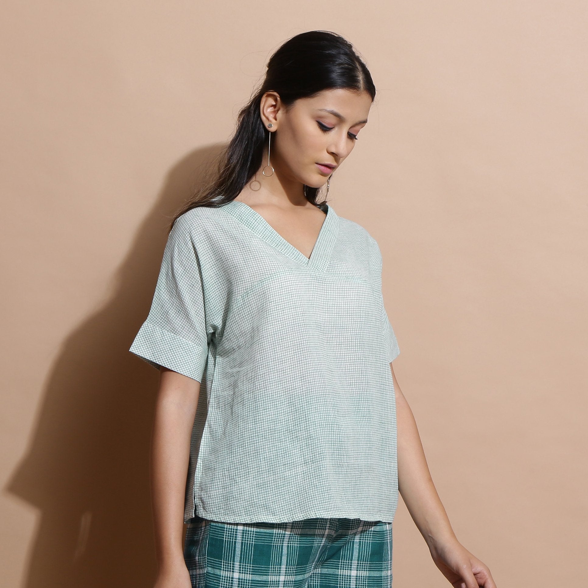 Right View of a Model wearing Light Green Checks Handspun Cotton Muslin V-Neck Top