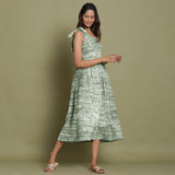 Right View of a Model wearing Light Green Shibori One-Shoulder Midi Dress