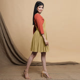 Right View of a Model wearing Light Khakhi Cotton Flax Knee Length Criss-Cross Back Dress