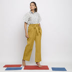 Right View of a Model wearing Light Yellow Vegetable Dyed Handspun Cotton Elasticated Wide Legged Paperbag Pant
