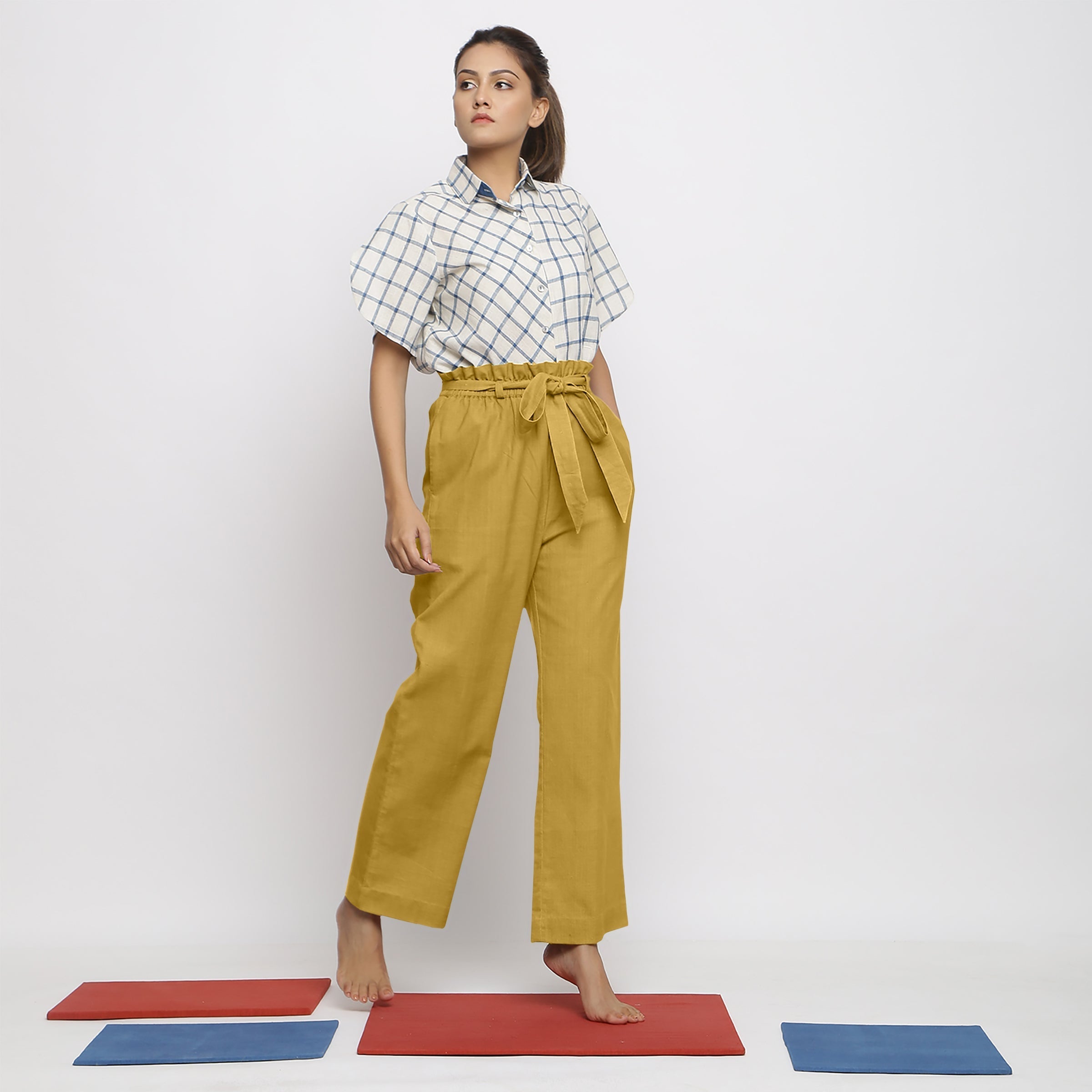 Right View of a Model wearing Light Yellow Vegetable Dyed Handspun Cotton Elasticated Wide Legged Paperbag Pant