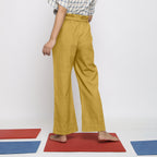 Back View of a Model wearing Light Yellow Vegetable Dyed Handspun Cotton Elasticated Wide Legged Paperbag Pant