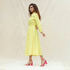 Left View of a Model wearing Light Yellow Handspun Cotton Yoked Button-Down Midi Dress