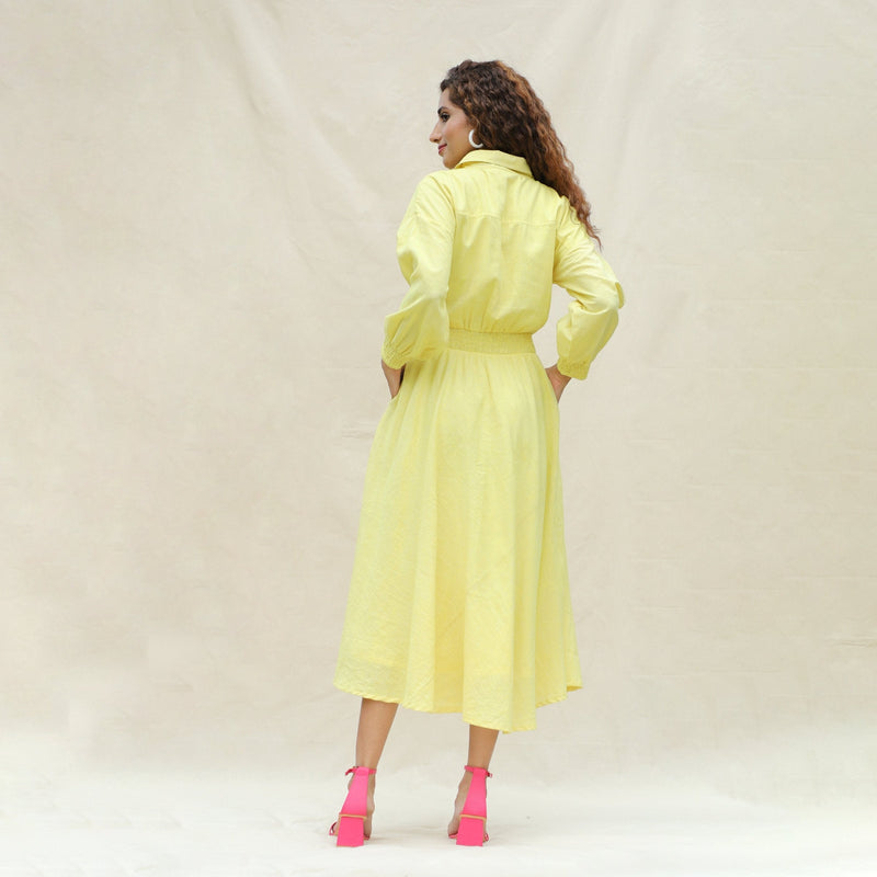 Back View of a Model wearing Light Yellow Handspun Cotton Yoked Button-Down Midi Dress