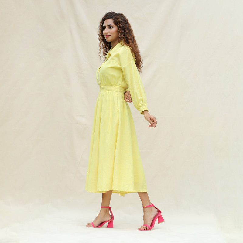 Left View of a Model wearing Light Yellow Handspun Cotton Yoked Button-Down Midi Dress