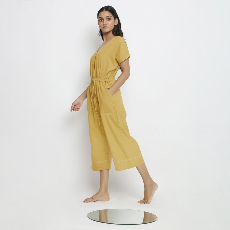 Left View of a Model wearing Light Yellow Vegetable Dyed Button-Down Jumpsuit