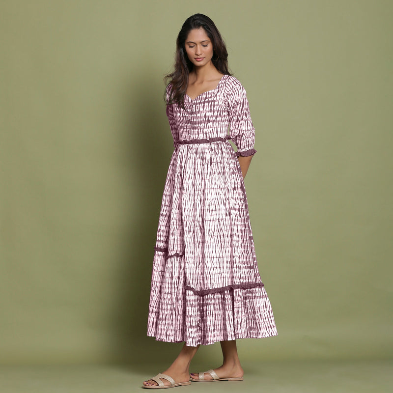 Left View of a Model wearing Maroon Shibori Asymmetrical Tier Maxi Dress