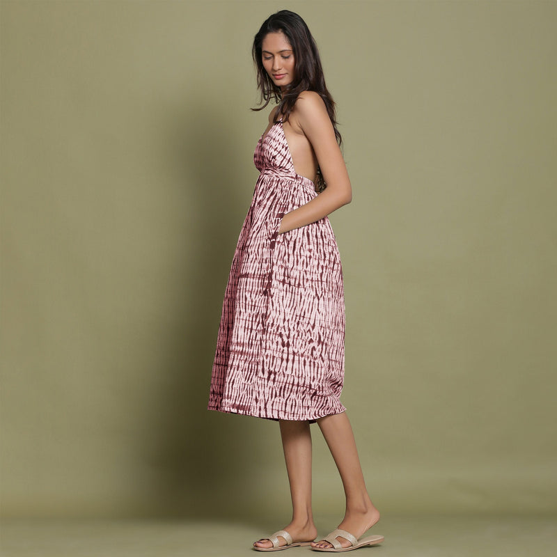 Left View of a Model wearing Maroon Shibori Halter Neck Gathered Dress