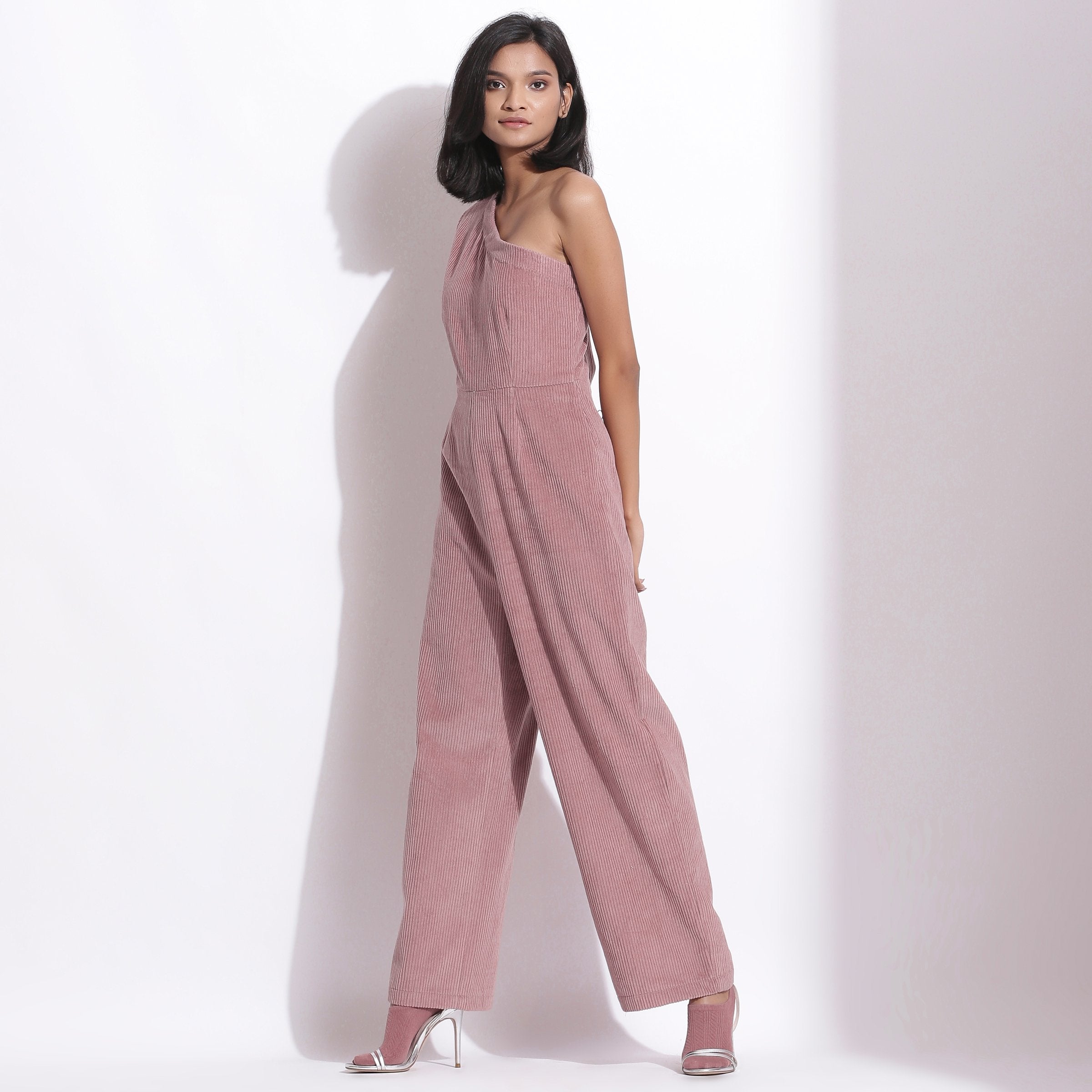Left View of a Model wearing Mauve Warm Cotton Corduroy Ankle Length One-Shoulder Jumpsuit