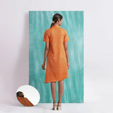 Back View of a Model wearing Melon Orange Mirrored Asymmetrical Shirt Dress