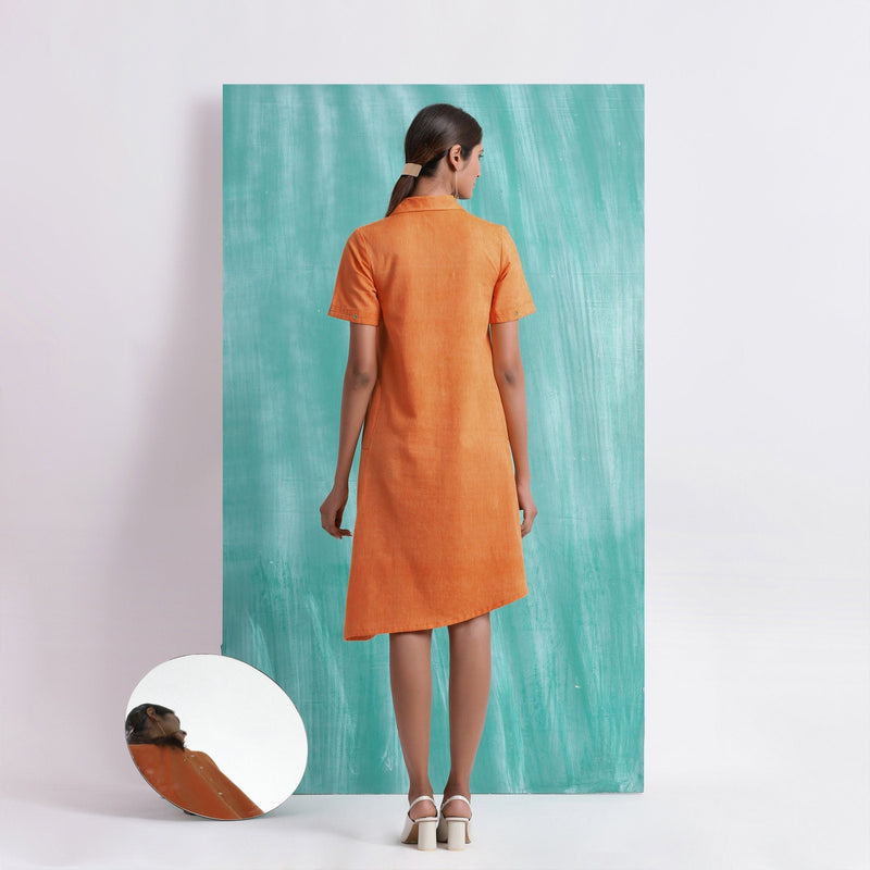 Back View of a Model wearing Melon Orange Mirrored Asymmetrical Shirt Dress