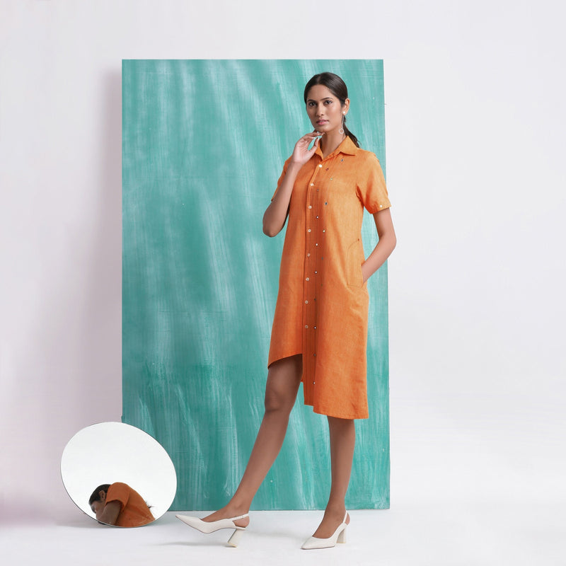 Left View of a Model wearing Melon Orange Mirrored Asymmetrical Shirt Dress