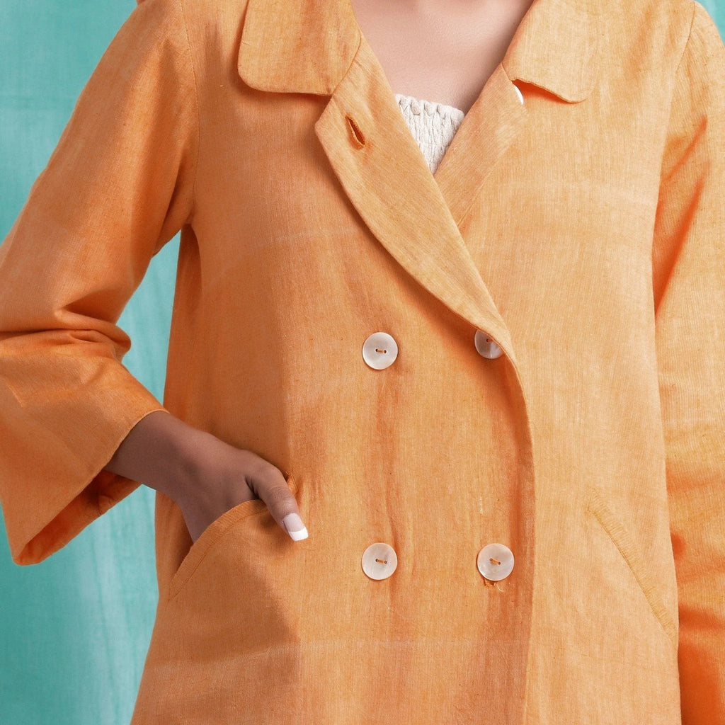 Front Detail of a Model wearing Melon Orange Welt Pocket Handwoven Coat