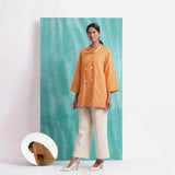 Front View of a Model wearing Melon Orange Welt Pocket Handwoven Coat