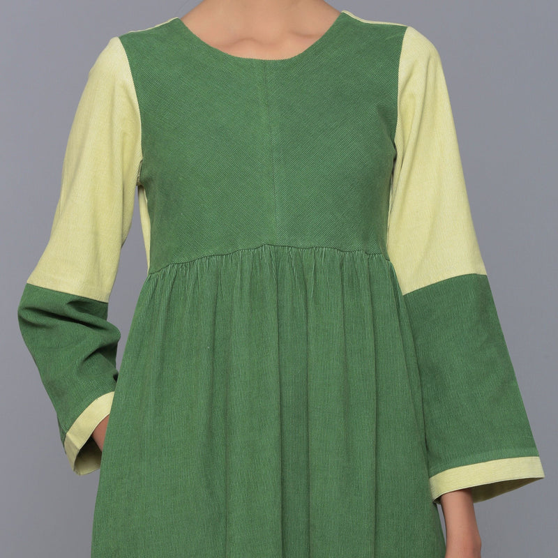 Front Detail of a Model wearing Moss Green Corduroy Tier Gathered Dress