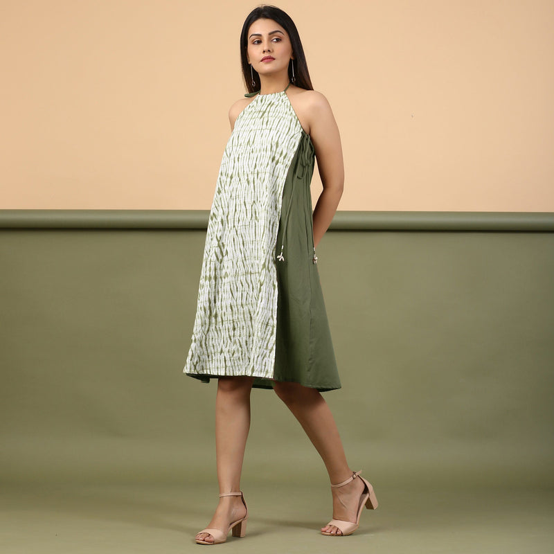 Left View of a Model wearing Moss Green Shibori Halter Neck A-Line Dress