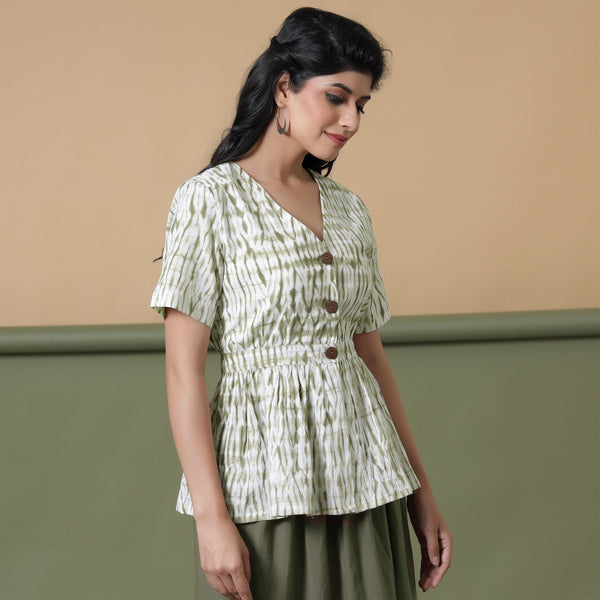 Right View of a Model wearing Moss Green Shibori Peplum Top