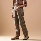 Left View of a Model wearing Warm Muddy Green Kalamkari Straight Pants