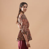 Right View of a Model wearing Muddy Red Kalamkari Block Print Cotton Peplum Top