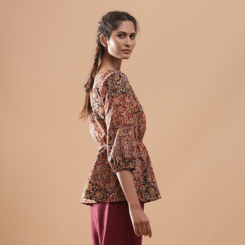 Right View of a Model wearing Muddy Red Kalamkari Block Print Cotton Peplum Top