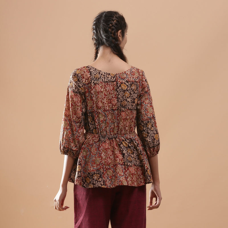 Back View of a Model wearing Muddy Red Kalamkari Block Print Cotton Peplum Top