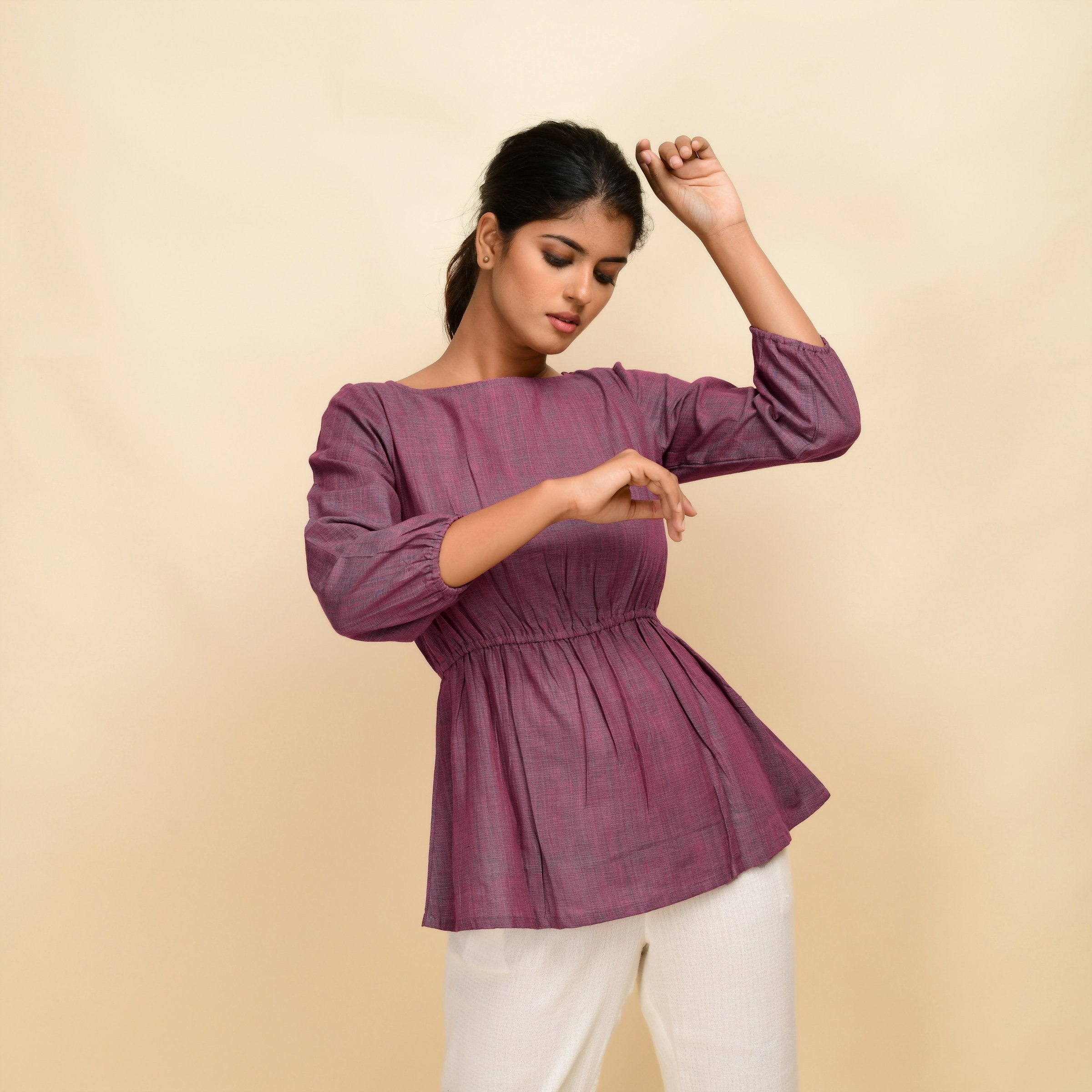 Front View of a Model wearing Mulberry Yarn Dyed Handspun Cotton Round Neck Peplum Top