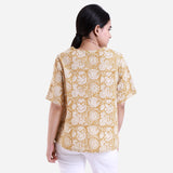 Back View of a Model wearing Mustard Bagru Block Print Cotton Flared Top