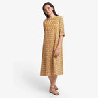 Front View of a Model wearing Mustard Block Printed Cotton Midi Yoke Dress