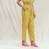Right View of a Model wearing Mustard Handspun Cotton High-Rise Elasticated Paperbag Pant