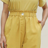 Front Detail of a Model wearing Mustard Handspun Cotton High-Rise Elasticated Paperbag Pant