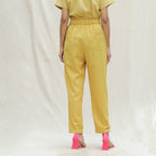Back View of a Model wearing Mustard Handspun Cotton High-Rise Elasticated Paperbag Pant