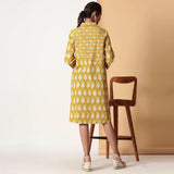 Back View of a Model wearing Mustard Paisley Bagru Block Printed Shirt Dress