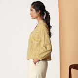 Left View of a Model wearing Mustard Striped Bagru Block Print Yoked Shirt