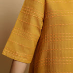 Front Detail of a Model wearing Mustard Striped Handwoven Godet Dress