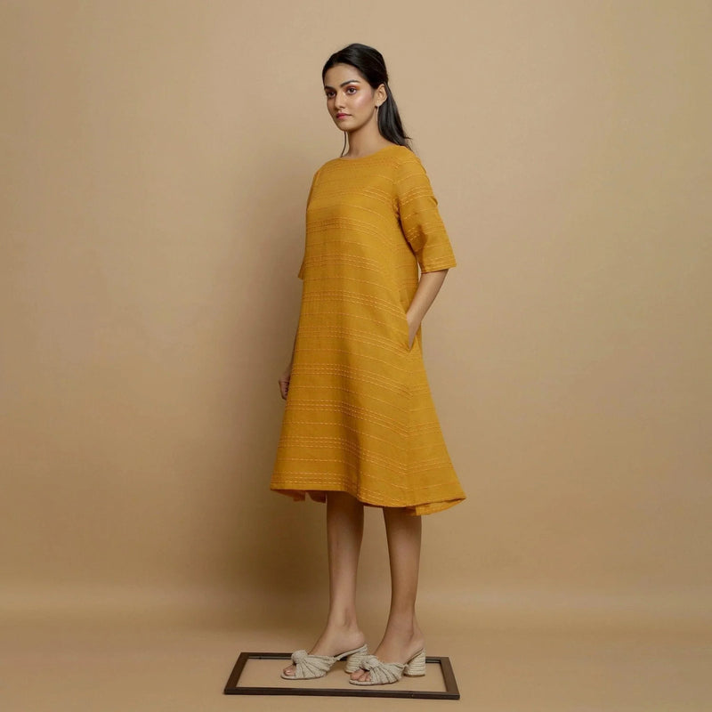 Left View of a Model wearing Mustard Striped Handwoven Godet Dress