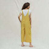 Back View of a Model wearing Mustard Vegetable Dyed Cotton Midi Dungaree Jumpsuit