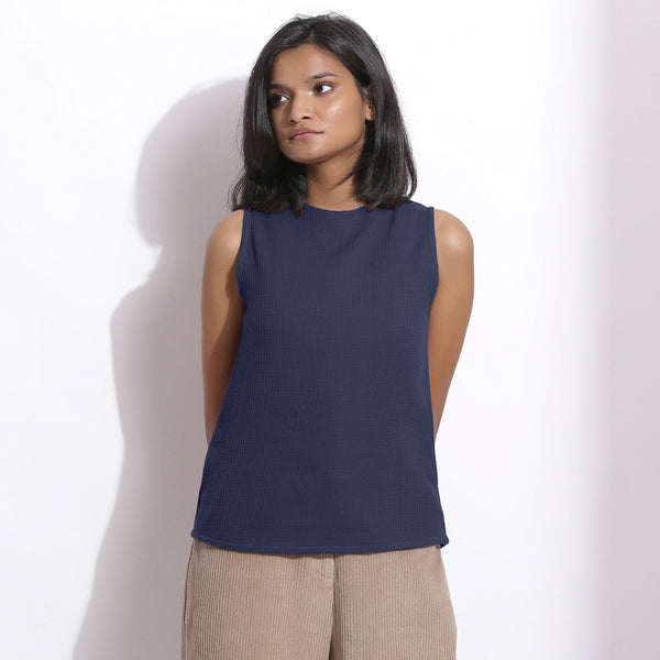 Front View of a Model wearing Navy Blue Cotton Waffle Funnel Neck Top