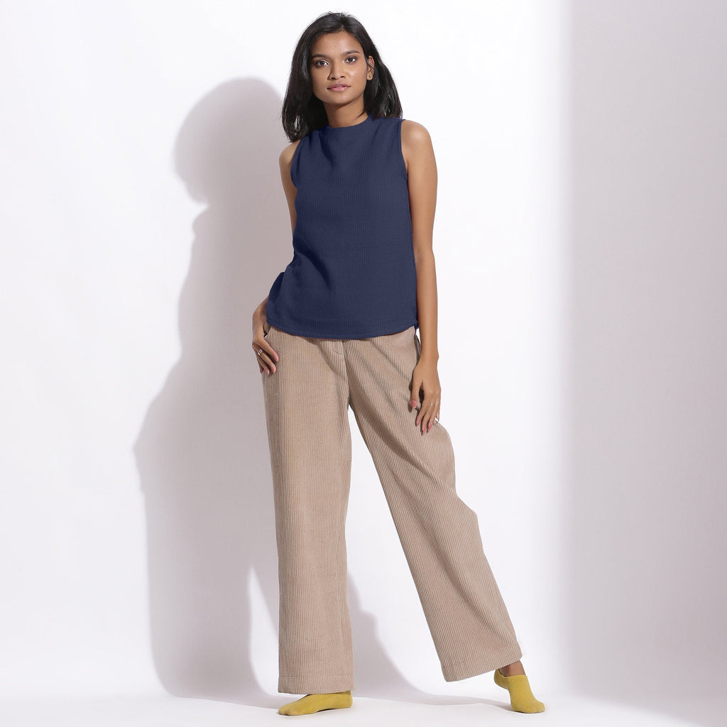 Front View of a Model wearing Navy Blue Cotton Waffle Funnel Neck Top
