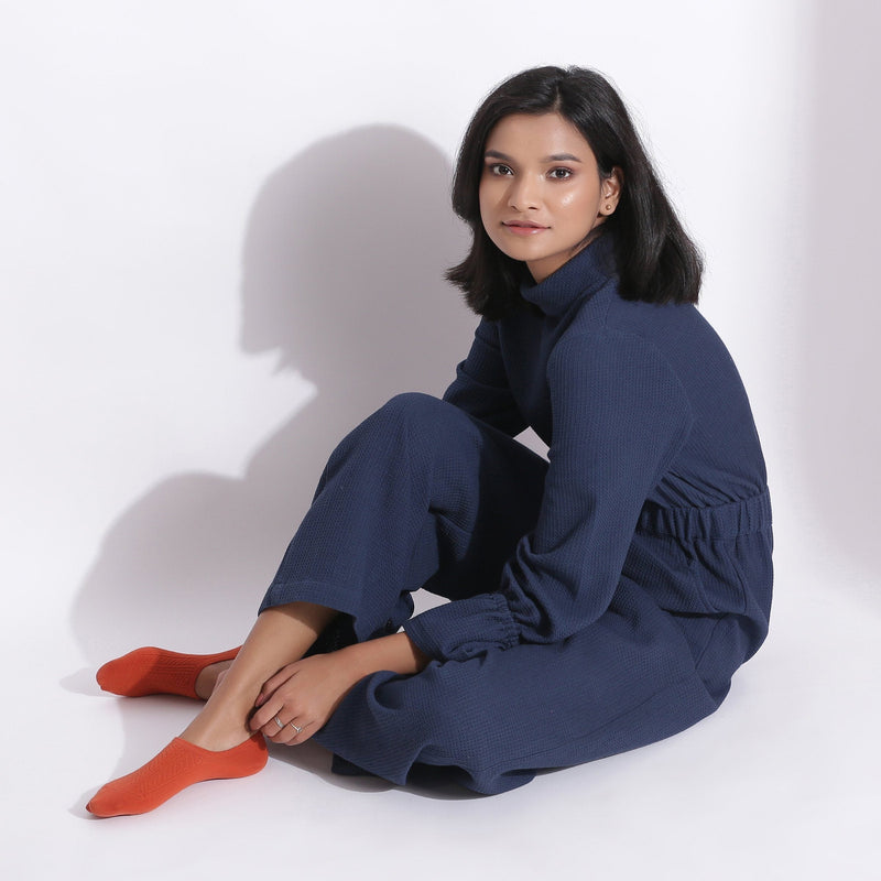 Left View of a Model wearing Navy Blue Cotton Waffle Turtle Neck Overalls