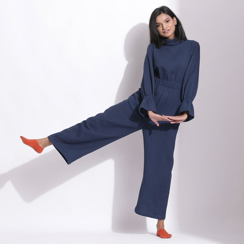 Front View of a Model wearing Navy Blue Cotton Waffle Turtle Neck Overalls