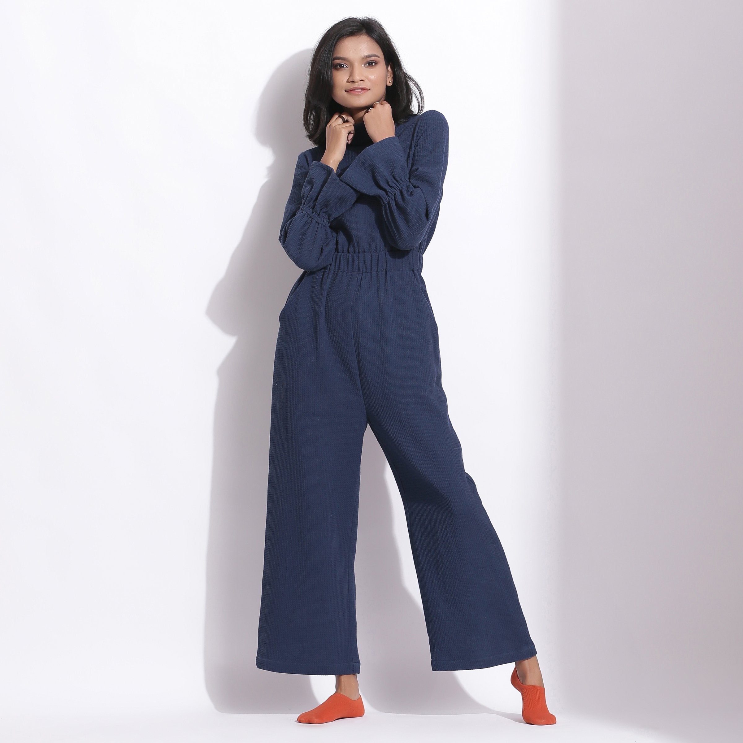 Front View of a Model wearing Navy Blue Cotton Waffle Turtle Neck Overalls