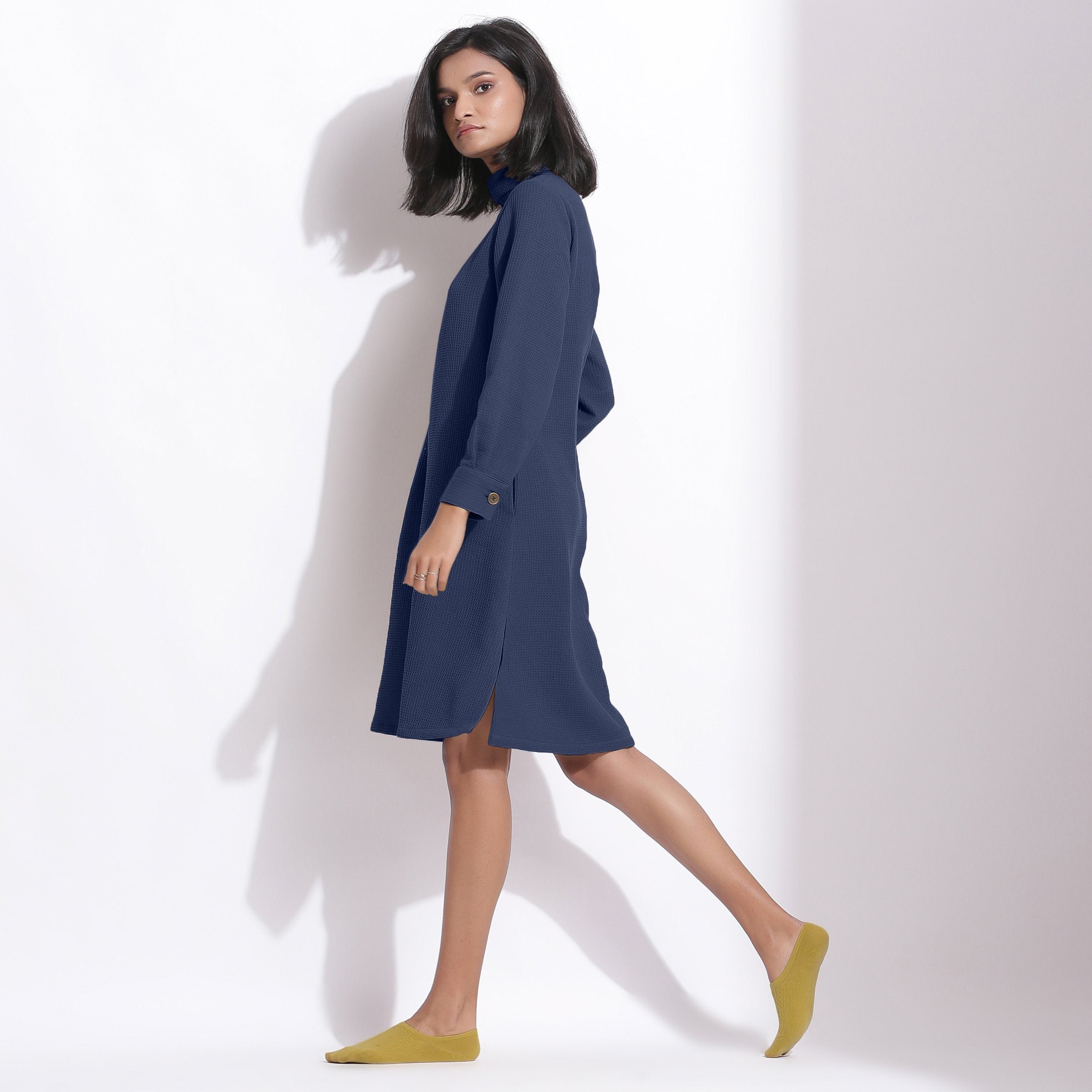 Left View of a Model wearing Navy Blue Cotton Waffle Turtleneck Dress