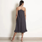Back View of a Model wearing Navy Blue Striped Halter Neck Frilled Dress