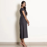 Right View of a Model wearing Navy Blue Striped Frilled Neck Flared Jumpsuit