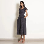 Left View of a Model wearing Navy Blue Striped Frilled Neck Flared Jumpsuit
