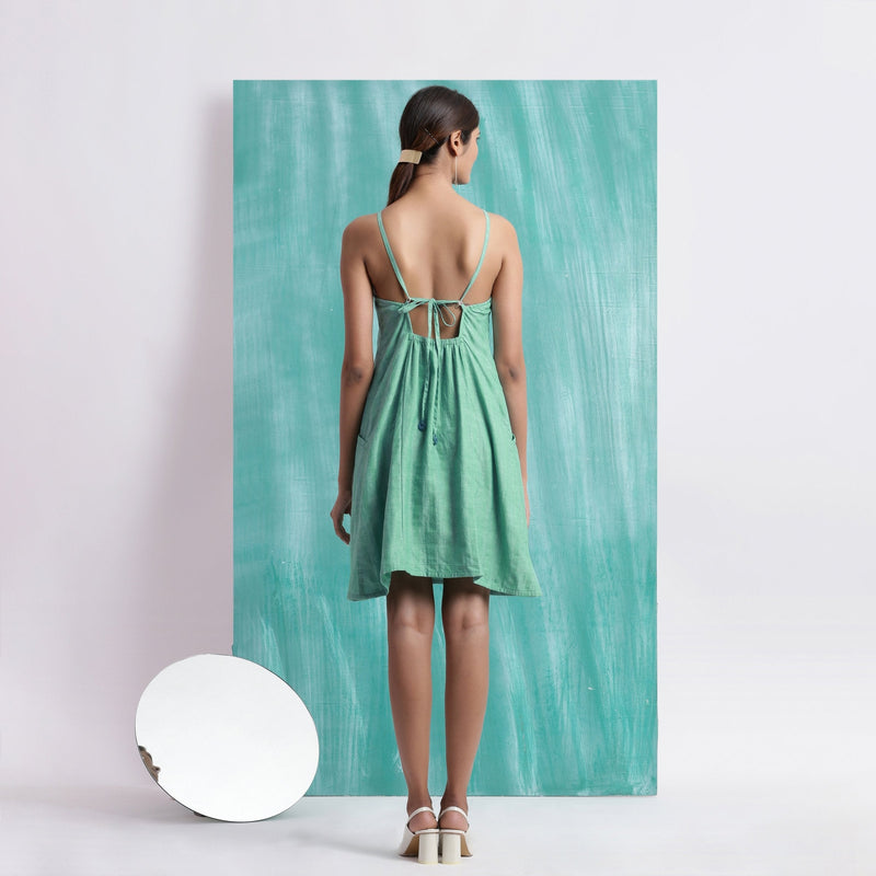 Back View of a Model wearing Ocean Green Handspun Cotton Criss-Cross A-Line Short Dress
